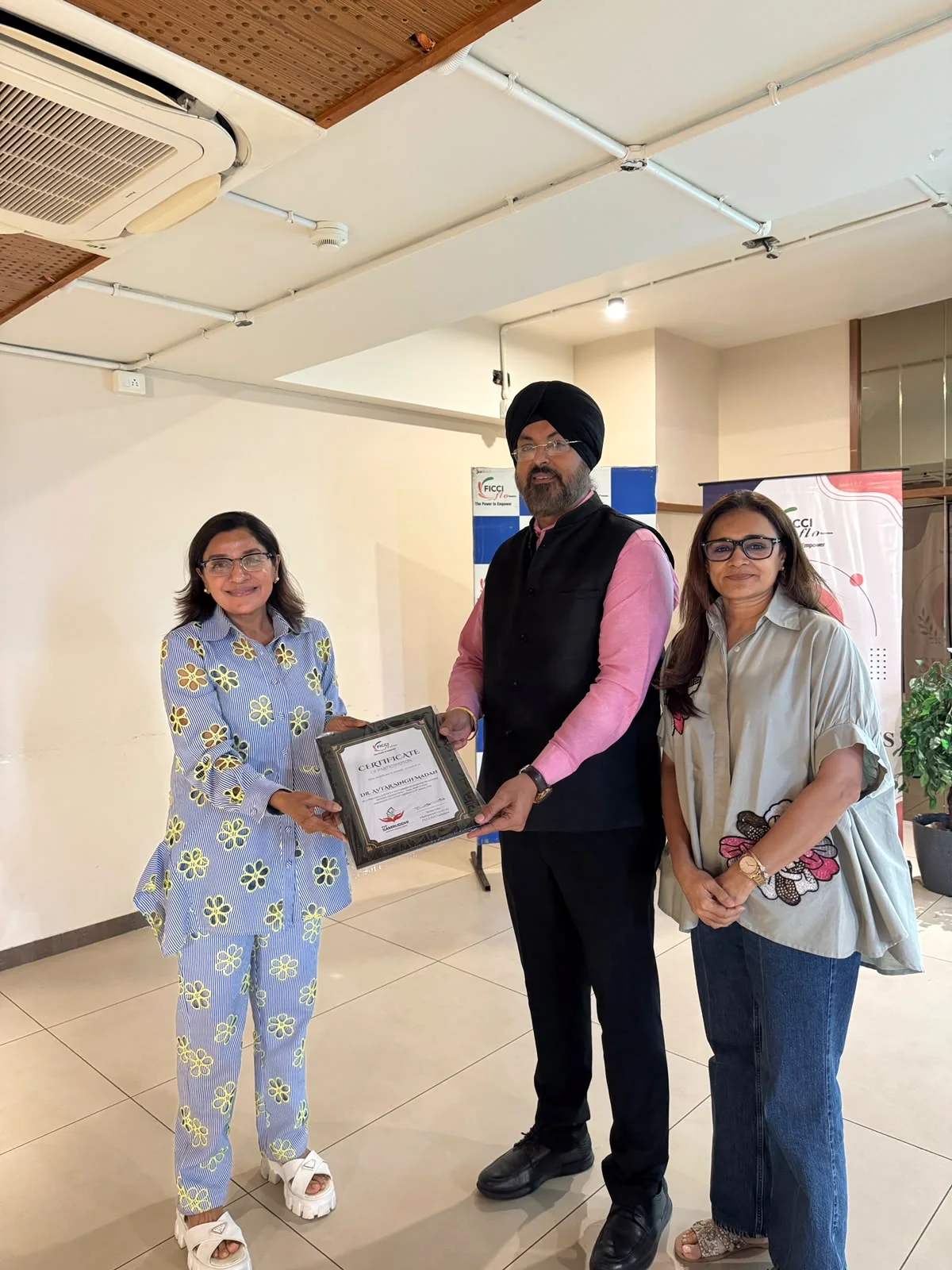 Dr. Avtar Singh Madan receiving a certificate after a women entrepreneurs financial literacy seminar